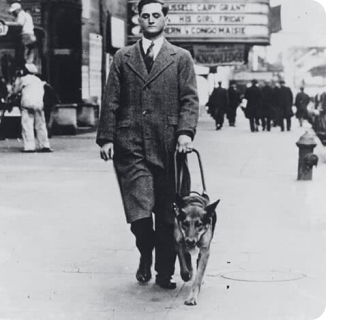 Image of Morris Frank walking with his dog Buddy